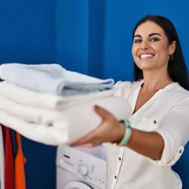Woman Presenting Clean Towels 600X600